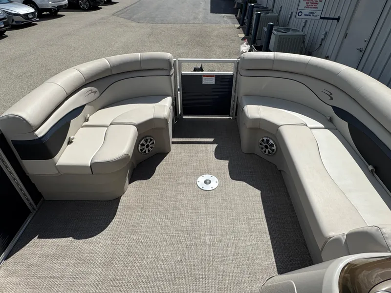 Slide: The Image of 2019 Bennington SX 21 SSRCX pontoon boat interior with beige seating and carpeted floor. - 16