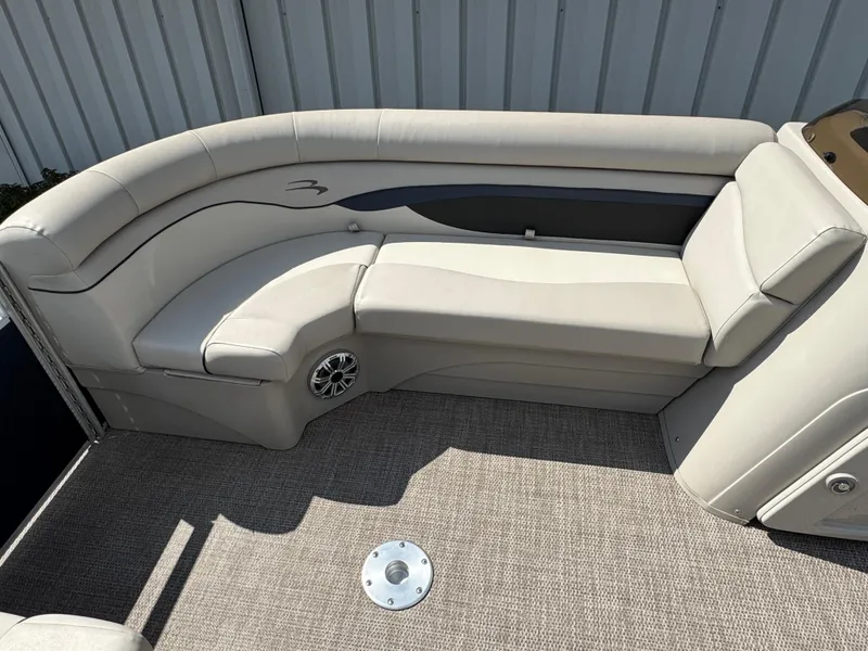 Slide: The Image of 2019 Bennington SX 21 SSRCX boat interior with beige seating and carpeted floor. - 17