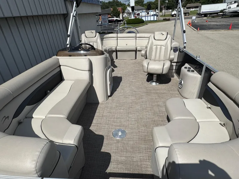 Slide: The Image of 2019 Bennington SX 21 SSRCX pontoon boat interior with beige seating and carpeted floor. - 19