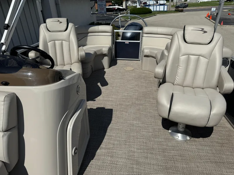 Slide: The Image of 2019 Bennington SX 21 SSRCX pontoon boat interior with plush seating and steering console. - 20
