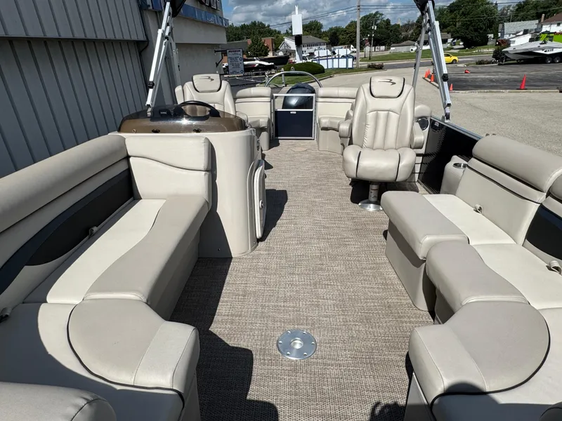 Slide: The Image of 2019 Bennington SX 21 SSRCX pontoon boat interior with beige seating and carpet. - 21