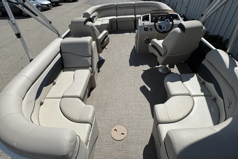 Slide: The Image of 2019 Bennington SX 21 SSRCX pontoon boat interior with beige seating and steering console. - 24