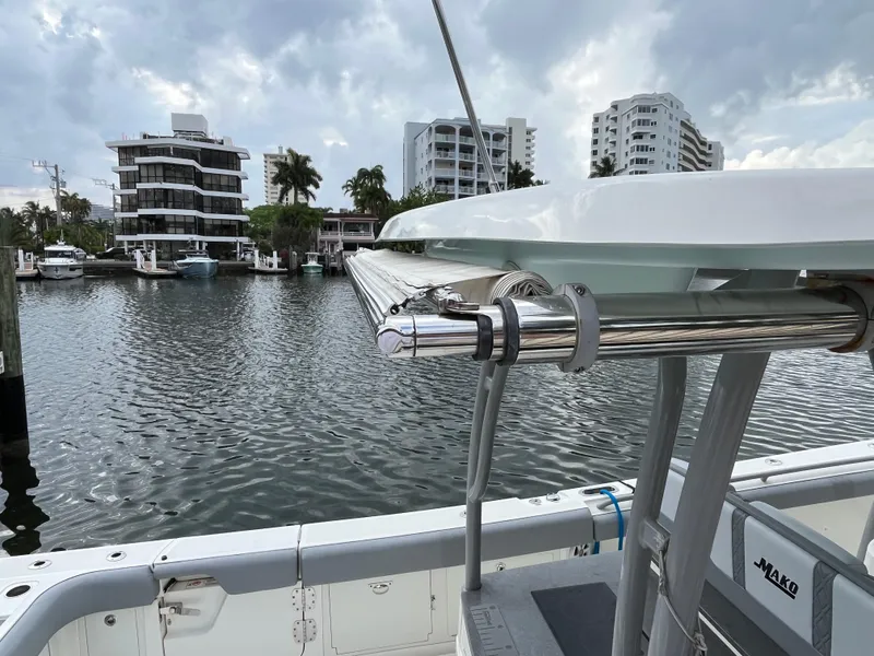 Slide: The Image of 2017 Mako 414 CC Bluewater boat docked near waterfront buildings under cloudy sky. - 11