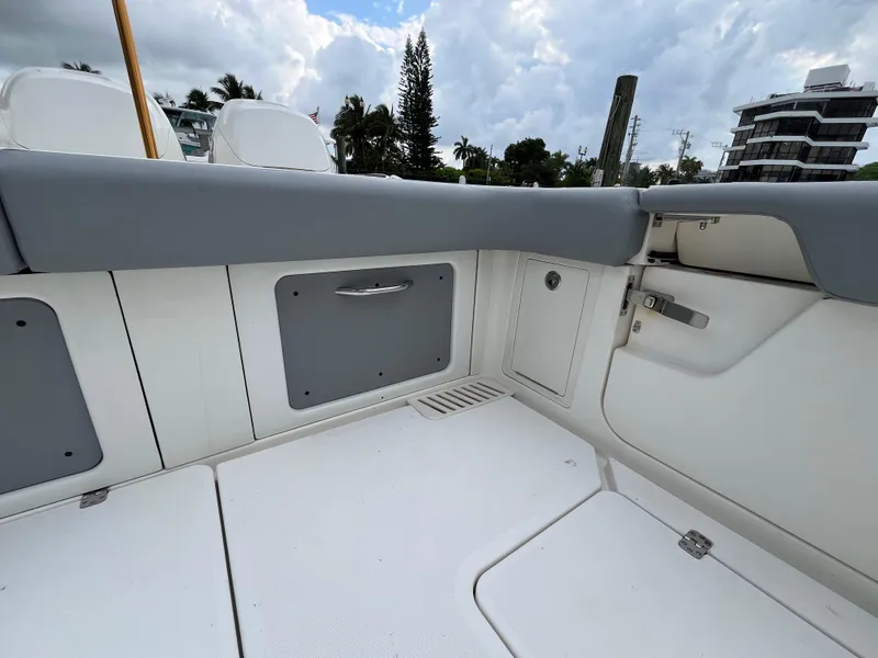 Slide: The Image of 2017 Mako 414 CC Bluewater boat interior with storage compartments and seating. - 13