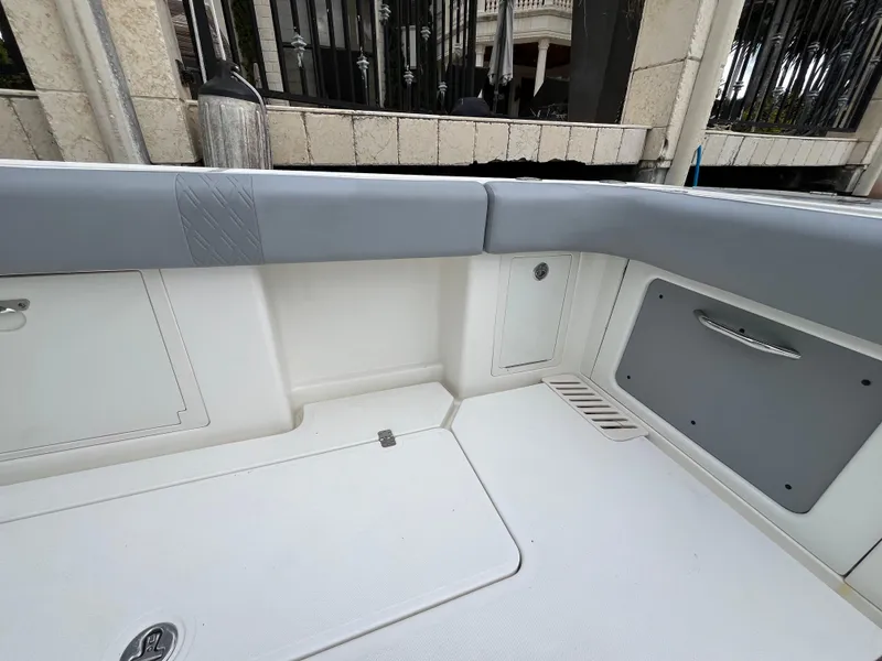 Slide: The Image of Interior view of 2017 Mako 414 CC Bluewater Family Edition boat, featuring sleek seating and storage. - 17