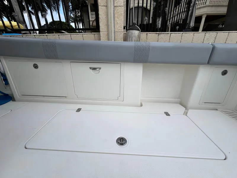 Slide: The Image of 2017 Mako 414 CC Bluewater boat interior with storage compartments and cushioned seating. - 18