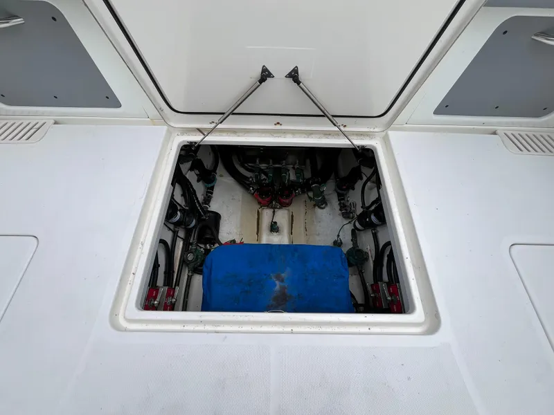 Slide: The Image of Open hatch of 2017 Mako 414 CC Bluewater Family Edition boat, revealing internal components. - 22