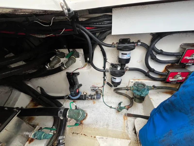 Slide: The Image of Engine compartment of a 2017 Mako 414 CC Bluewater Family Edition boat, showing wiring and components. - 25