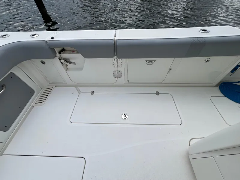 Slide: The Image of 2017 Mako 414 CC Bluewater boat deck with storage compartments and seating. - 27