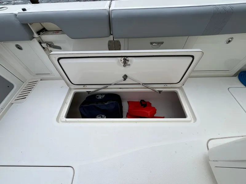 Slide: The Image of 2017 Mako 414 CC Bluewater boat storage compartment with life jackets. - 28