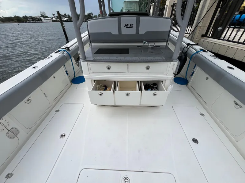 Slide: The Image of 2017 Mako 414 CC Bluewater boat interior with open storage drawers and sink. - 39
