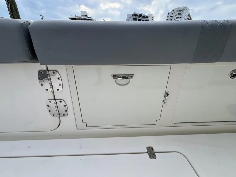 Slide: The Image of 2017 Mako 414 CC Bluewater Family Edition boat storage compartment with cushioned seating. - 42