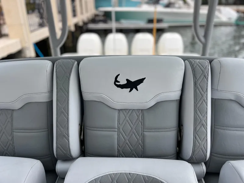 Slide: The Image of Gray boat seating with shark logo on a 2017 Mako 414 CC Bluewater Family Edition. - 44