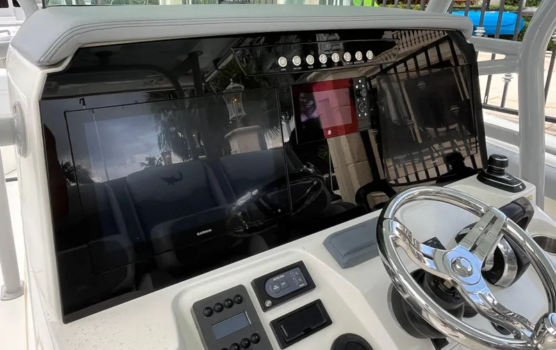 Slide: The Image of Control panel of 2017 Mako 414 CC Bluewater Family Edition boat with steering wheel. - 48