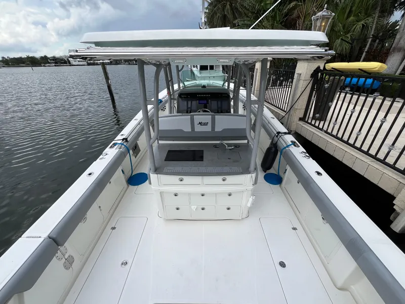 Slide: The Image of 2017 Mako 414 CC Bluewater Family Edition boat docked by waterfront. - 9