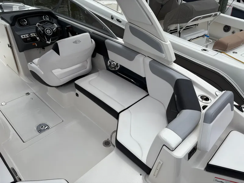 Slide: The Image of 2020 Chaparral 250 Suncoast boat interior with modern seating and steering console. - 10