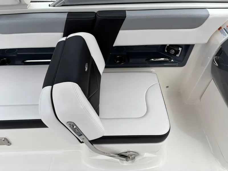 Slide: The Image of 2020 Chaparral 250 Suncoast boat seat with sleek black and white upholstery. - 12