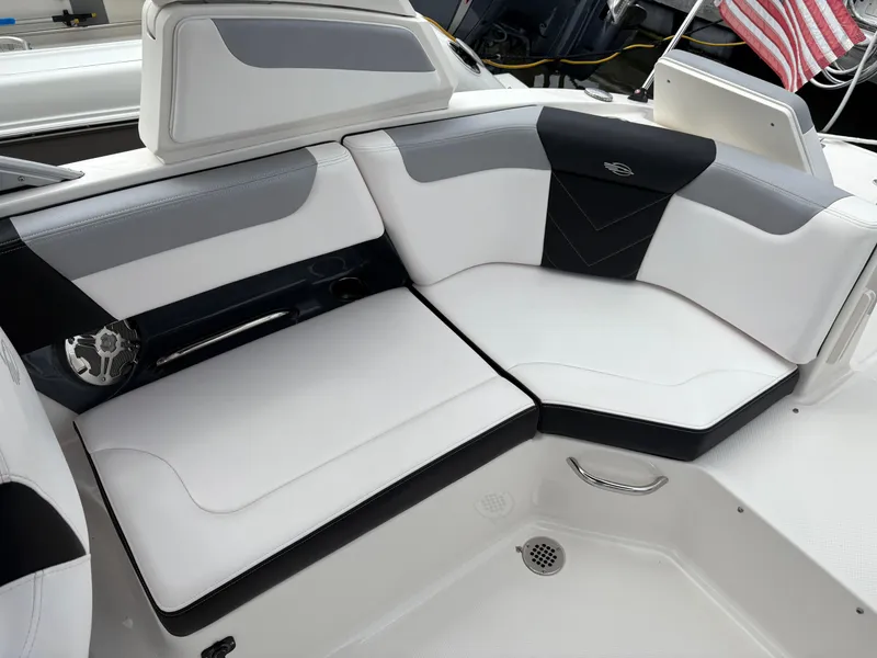 Slide: The Image of 2020 Chaparral 250 Suncoast boat interior with white and black seating. - 13