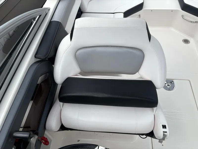 Slide: The Image of 2020 Chaparral 250 Suncoast boat seat, white and black upholstery, modern design. - 14