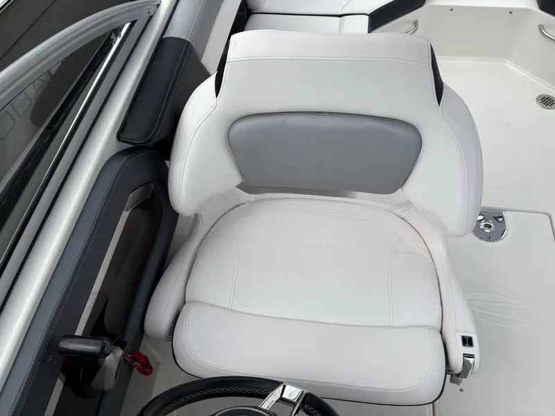 Slide: The Image of Captain's seat on 2020 Chaparral 250 Suncoast boat, featuring white and gray upholstery. - 15