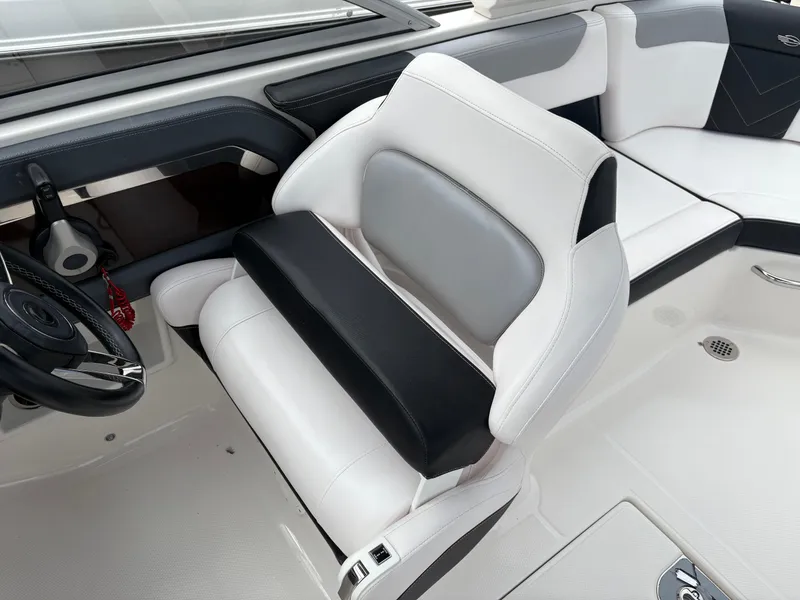 Slide: The Image of 2020 Chaparral 250 Suncoast boat interior with white and black seating. - 17