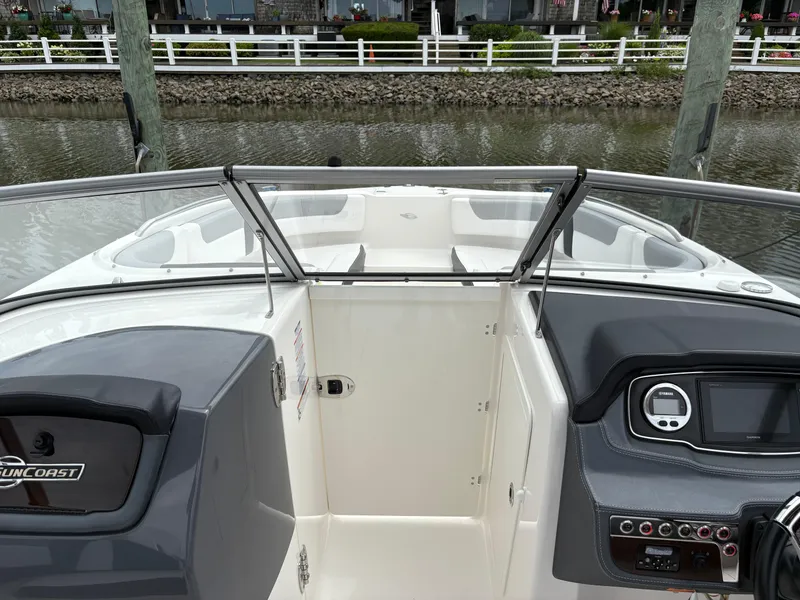 Slide: The Image of 2020 Chaparral 250 Suncoast boat interior with dashboard and open bow view. - 21