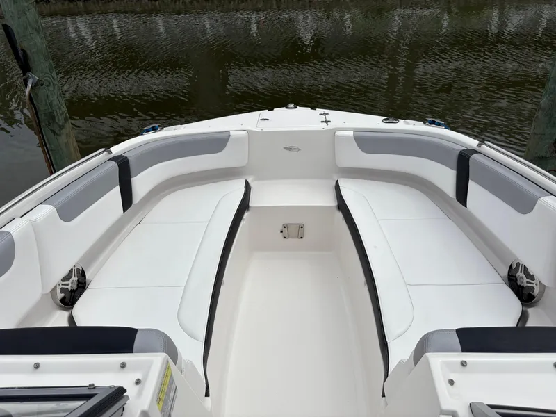 Slide: The Image of 2020 Chaparral 250 Suncoast boat interior with white seating and water view. - 22