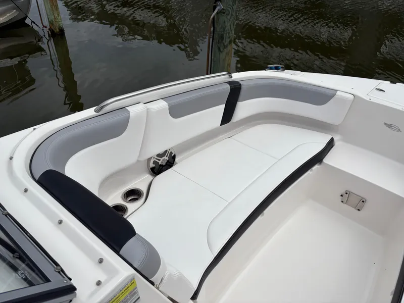 Slide: The Image of 2020 Chaparral 250 Suncoast boat interior with white and gray seating. - 23