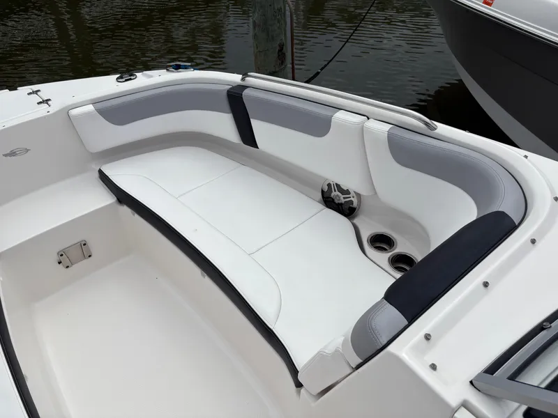 Slide: The Image of 2020 Chaparral 250 Suncoast boat interior with white seating and cup holders. - 24