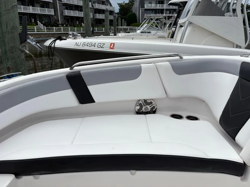 Slide: The Image of 2020 Chaparral 250 Suncoast boat interior with white seating and cup holders. - 25