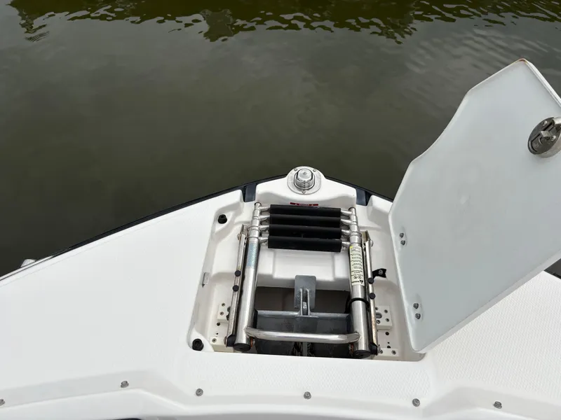 Slide: The Image of 2020 Chaparral 250 Suncoast boat with open storage compartment and ladder. - 27