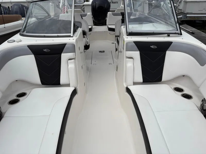 Slide: The Image of 2020 Chaparral 250 Suncoast boat interior with white seating and cup holders. - 28