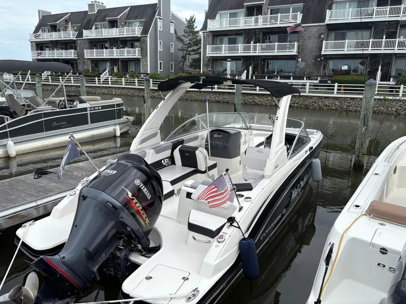 Slide: The Image of 2020 Chaparral 250 Suncoast boat docked near waterfront homes, featuring Yamaha engine. - 3