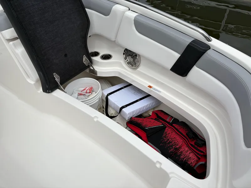 Slide: The Image of Storage compartment in 2020 Chaparral 250 Suncoast boat with life jackets and supplies. - 30