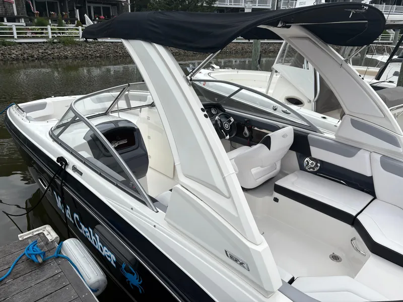 Slide: The Image of 2020 Chaparral 250 Suncoast boat docked, featuring sleek design and comfortable seating. - 5