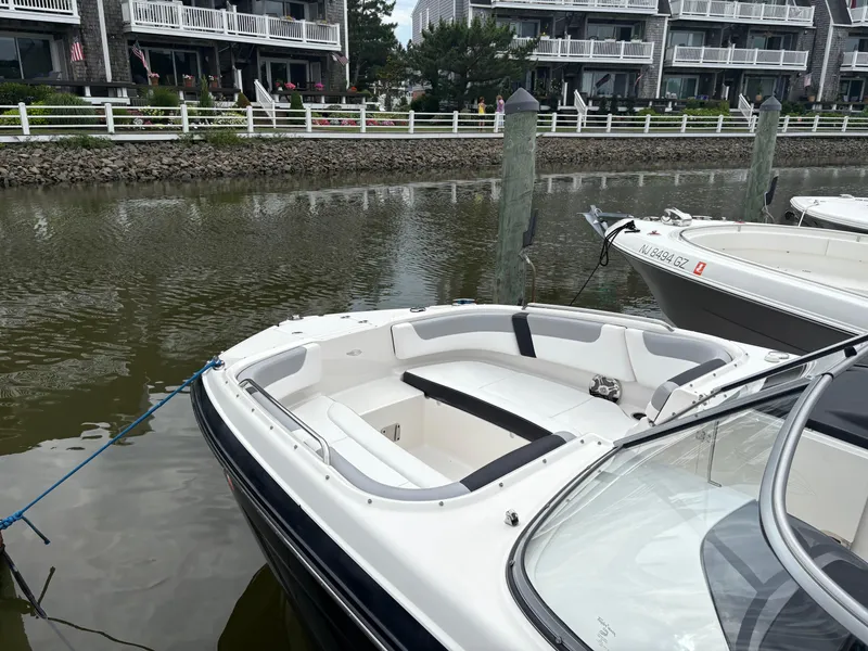 Slide: The Image of 2020 Chaparral 250 Suncoast boat docked near waterfront homes. - 6