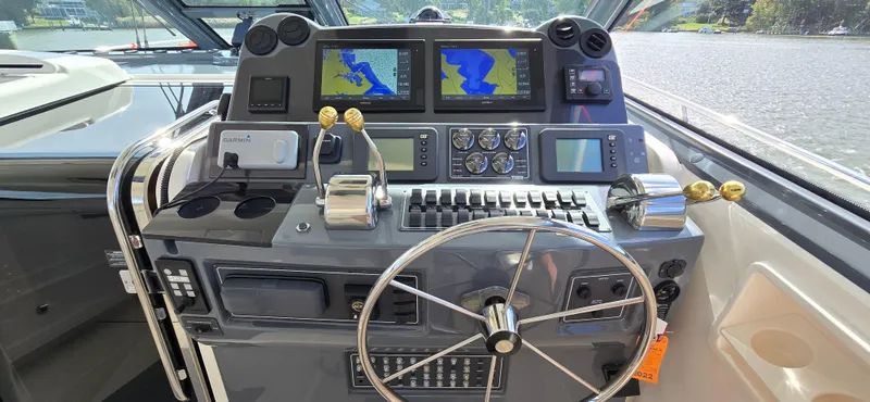 Slide: The Image of Helm of 2004 Tiara Yachts 5200 Sovran with navigation screens and controls. - 10