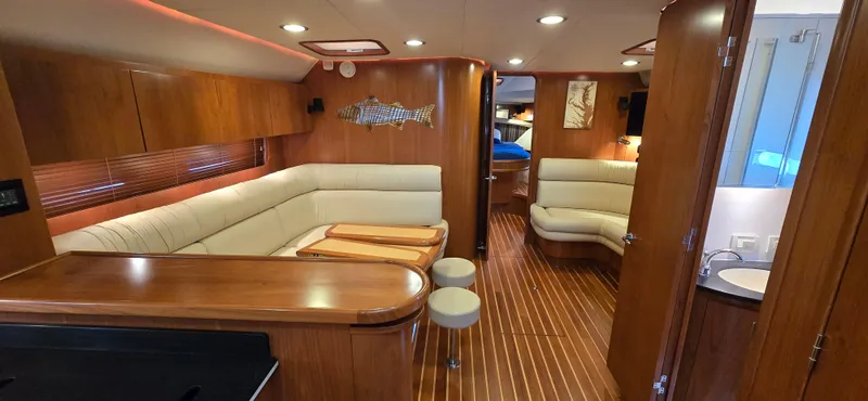 Slide: The Image of Luxurious interior of 2004 Tiara Yachts 5200 Sovran with elegant wood finishes and plush seating. - 14
