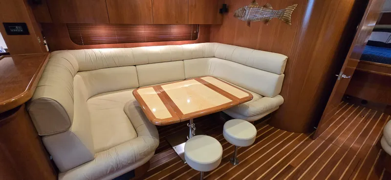 Slide: The Image of Luxurious 2004 Tiara Yachts 5200 Sovran interior with elegant seating and wooden accents. - 15