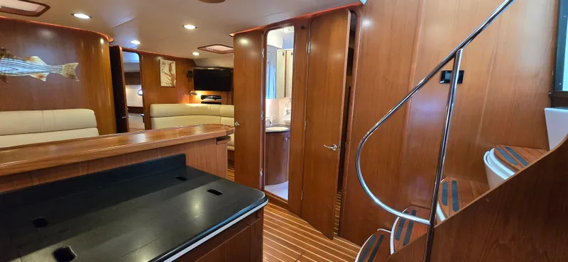 Slide: The Image of Luxurious interior of 2004 Tiara Yachts 5200 Sovran with wood finishes and modern amenities. - 16