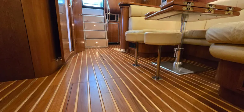 Slide: The Image of Luxurious interior of 2004 Tiara Yachts 5200 Sovran with elegant wood flooring and plush seating. - 17