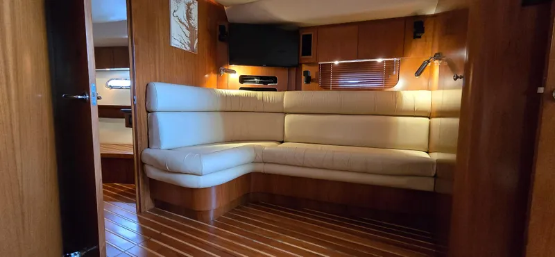 Slide: The Image of Luxurious interior of 2004 Tiara Yachts 5200 Sovran with plush seating and wooden flooring. - 19