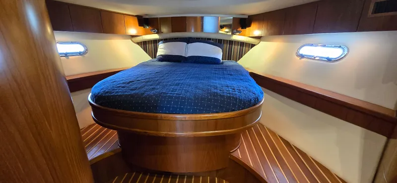 Slide: The Image of Luxurious cabin interior of 2004 Tiara Yachts 5200 Sovran with cozy bed and wooden accents. - 22