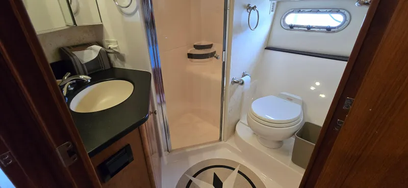 Slide: The Image of Luxurious bathroom in 2004 Tiara Yachts 5200 Sovran, featuring modern fixtures and elegant design. - 24