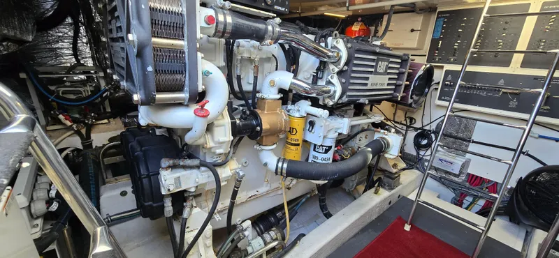 Slide: The Image of Engine room of 2004 Tiara Yachts 5200 Sovran, featuring CAT marine engine and control panels. - 27