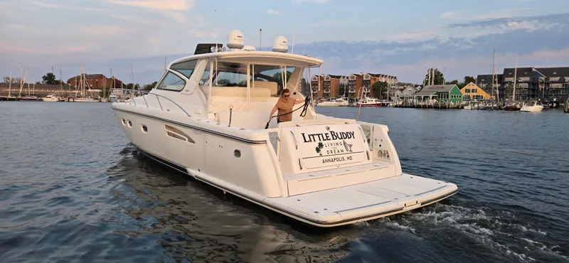 Slide: The Image of 2004 Tiara Yachts 5200 Sovran cruising in a scenic harbor setting. - 31