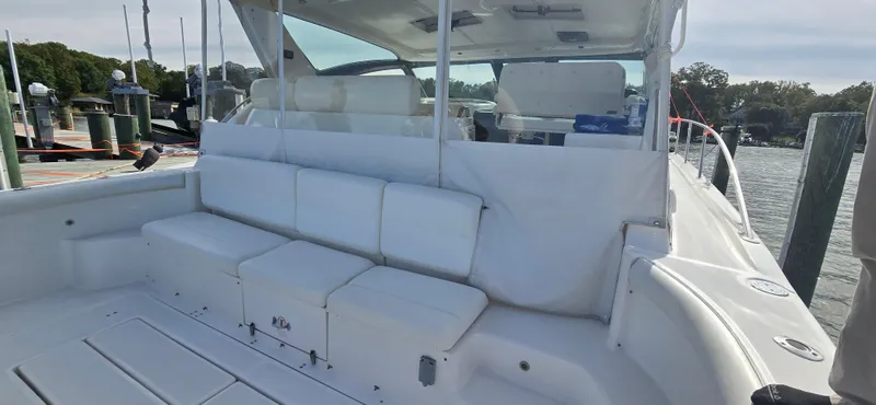 Slide: The Image of 2004 Tiara Yachts 5200 Sovran boat with spacious white seating area at dock. - 6