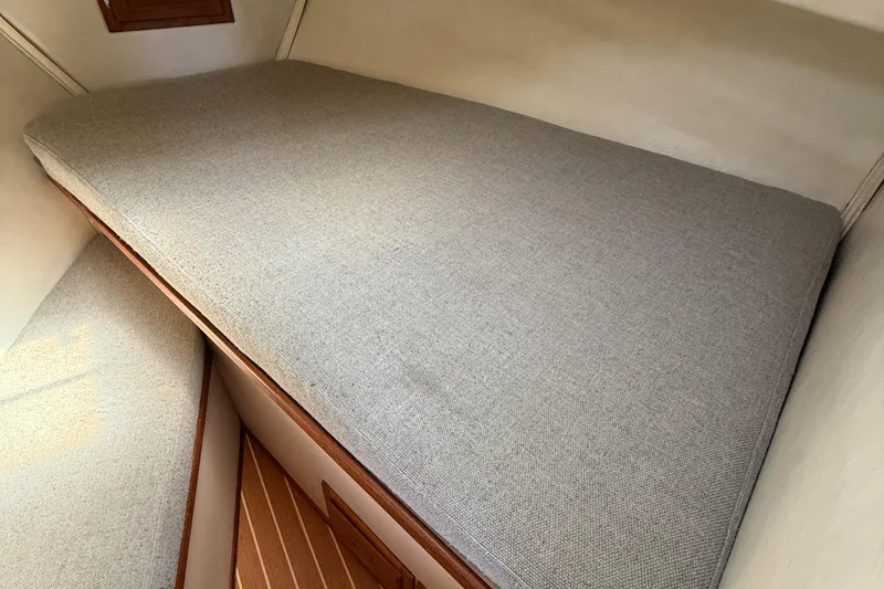 Slide: The Image of Interior cabin of 1997 Nordic Tug 26 with gray cushioned bed. - 14