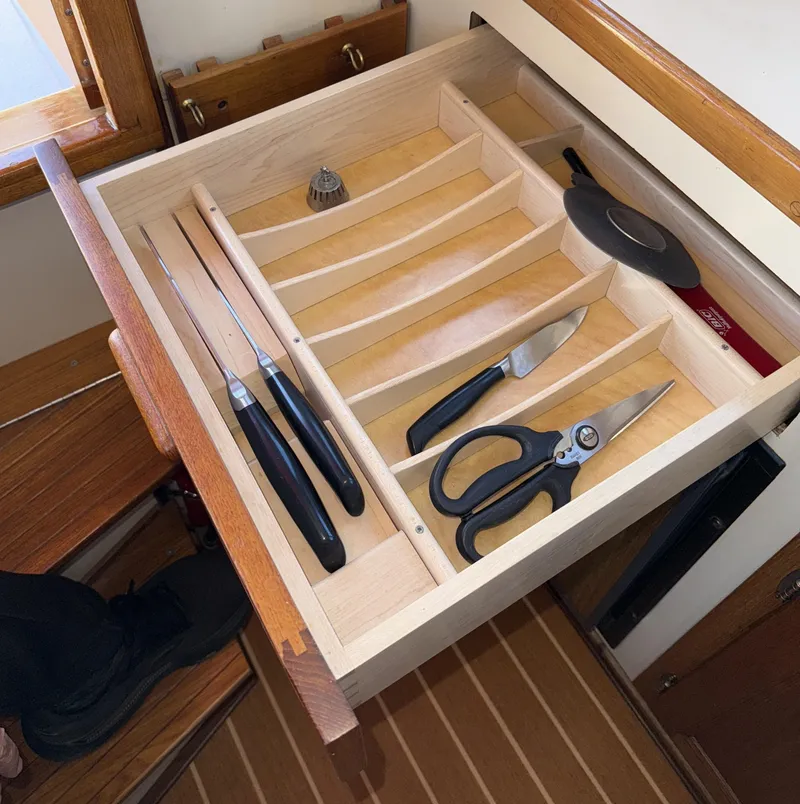 Slide: The Image of Drawer with organized kitchen utensils on a 1997 Nordic Tug 26 boat. - 18