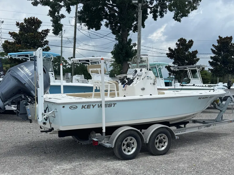 The Image of 2016 Key West 210BR boat on trailer with Yamaha engine, parked outdoors. - 1